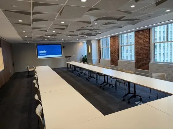 Ceiling speakers and acoustic panels in a Studio by Tishman Speyer meeting room