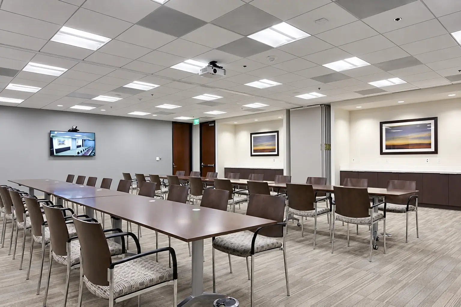 Christie, Parker & Hale conference room with ceiling projector, video display, and training tables
