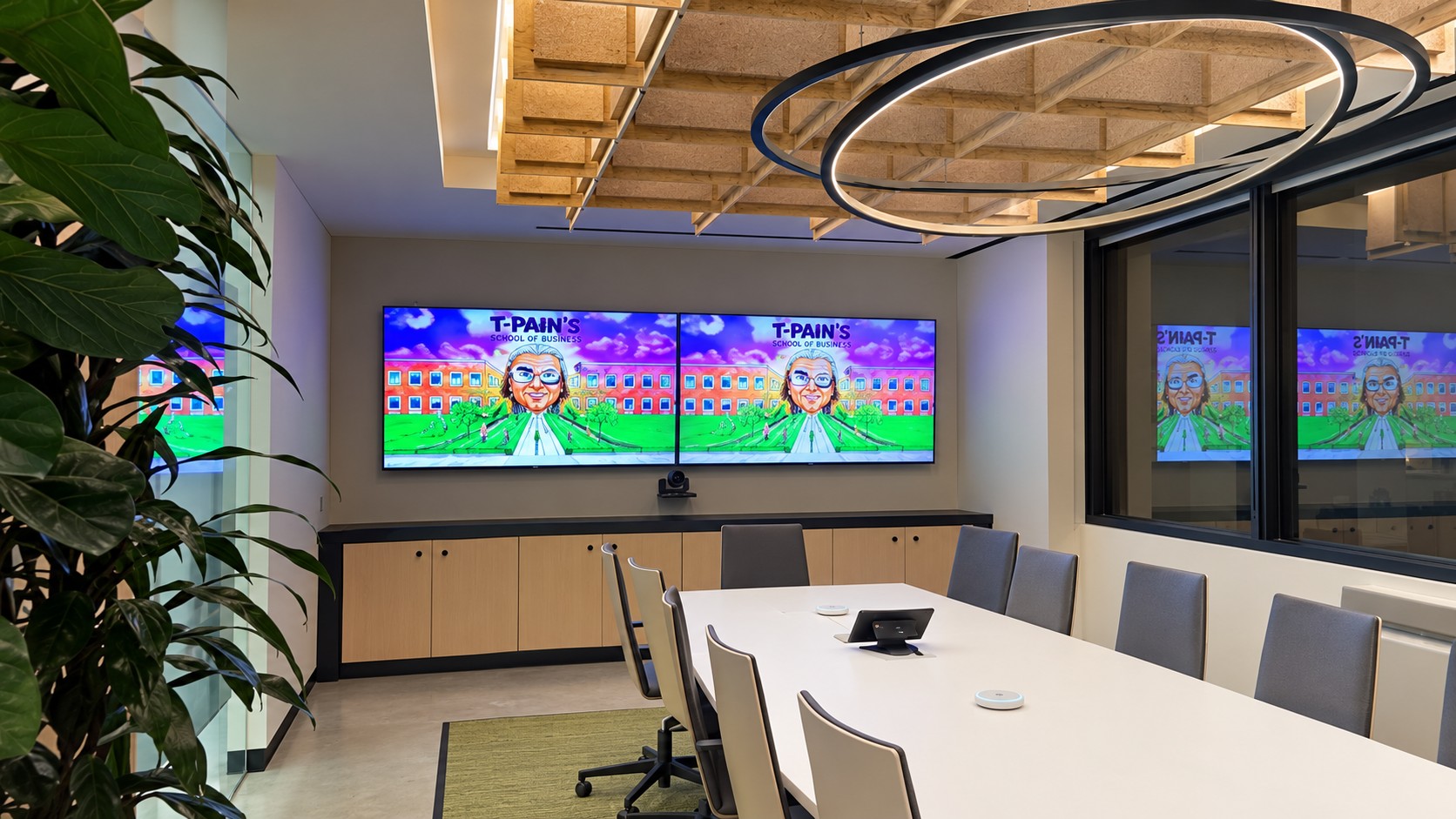 Fuse Media boardroom with dual displays, conferencing camera, tabletop microphones, and touch controller