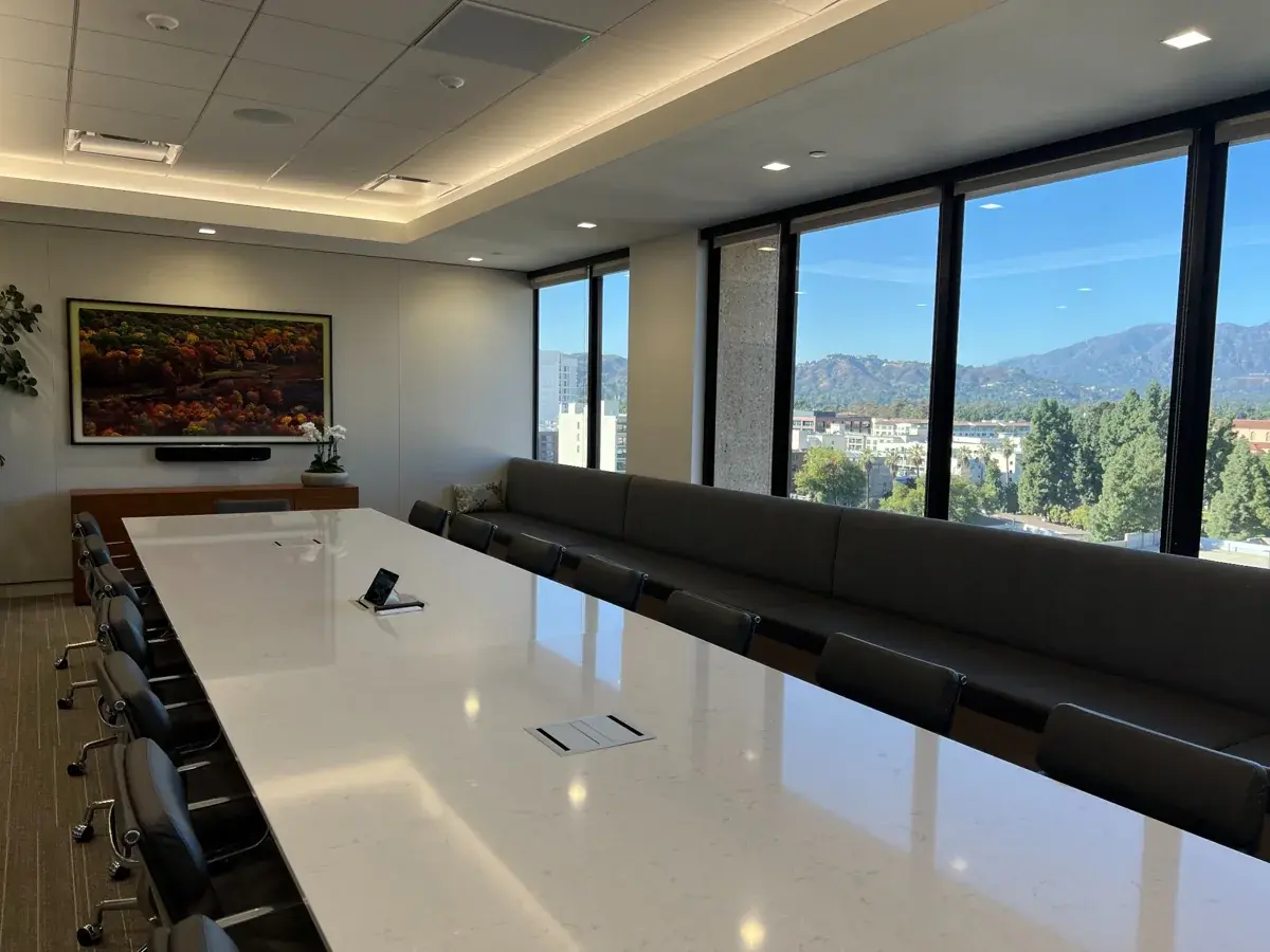 Whittier Trust Pasadena boardroom with conference table, display and video conferencing equipment